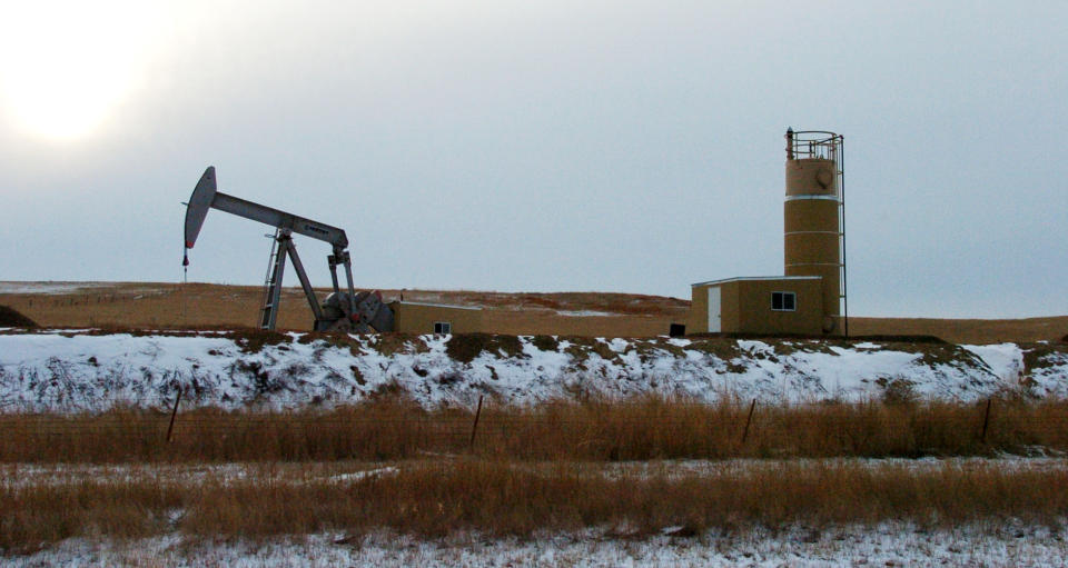 This Feb. 28, 2012 photo shows an oil well near Sidney, Mont. Sidney is experiencing a boom spurred by companies seeking to extract oil from the massive Bakken formation beneath western North Dakota and eastern Montana. More than 16 million barrels of crude are now being pumped every month from the massive Bakken oil field beneath eastern Montana. But Sidney's new-found prosperity doesn't dull the sting of the recent kidnapping and apparent murder of a local teacher, Sherry Arnold, who authorities allege was snatched from a Sidney, Mont., street. (AP Photo/Matthew Brown)