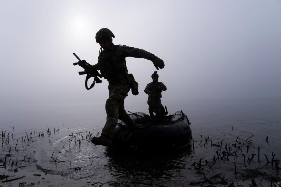 A Ukrainian serviceman jumps out of the boat on the shore of Dnipro river at the frontline near Kherson, Ukraine, in October (Copyright 2023 The Associated Press. All rights reserved.)