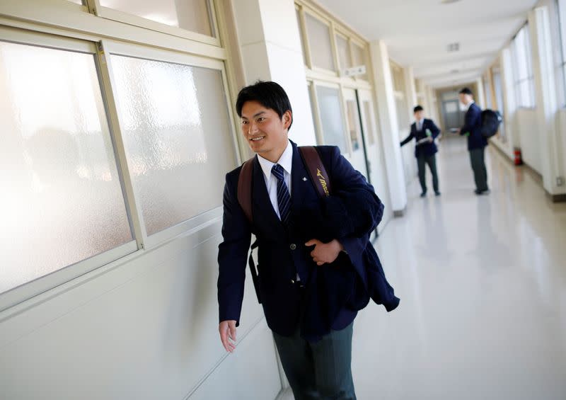 Ryoma Ouchi, an ace pitcher at Fukushima Commercial High School baseball team from Iitate, walks inside the school in Fukushima, Japan