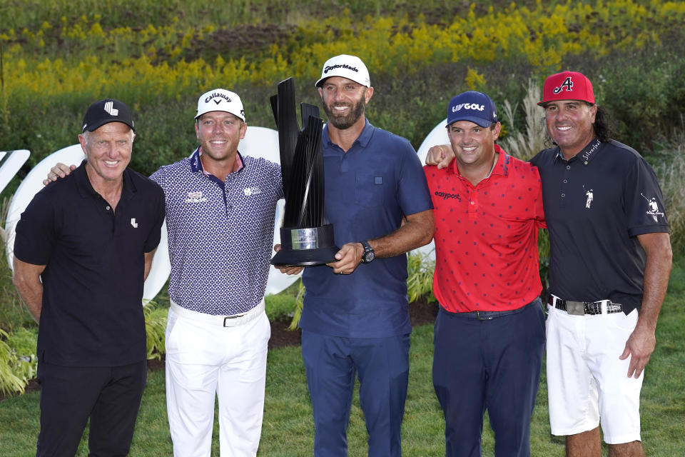 LIV Golf CEO Greg Norman, left, stands with the 4 Aces GC team, from left, Talor Gooch, Captian Dustin Johnson, Patrick Reed and Pat Perez, after winning the team's fourth straight tournament at the LIV Golf Invitational-Chicago tournament Sunday, Sept. 18, 2022, in Sugar Hill, Ill. (AP Photo/Charles Rex Arbogast)