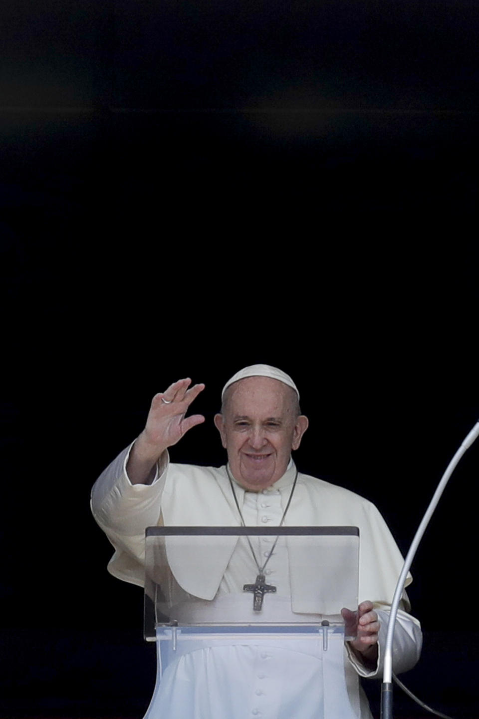 Pope Francis delivers his blessing as he recites the Angelus noon prayer from the window of his studio overlooking St.Peter's Square, at the Vatican, Sunday, Sept. 13, 2020. (AP Photo/Andrew Medichini)