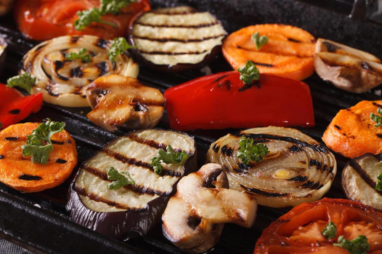 grill-marked vegetables cooking on a grill