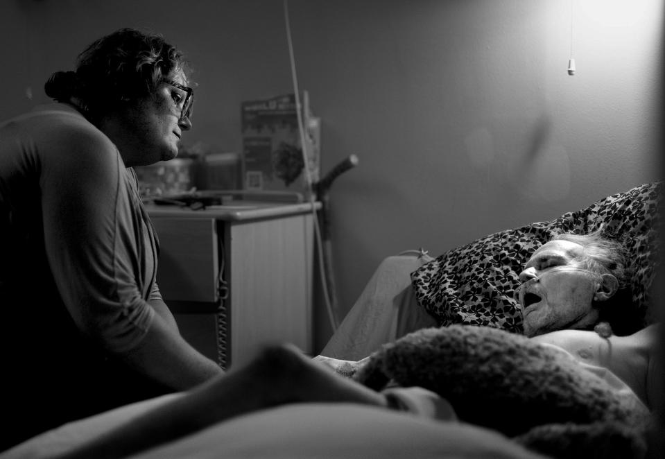 Kellie Mieremet, community engagement manager at The INN Between, sits vigil at Paul Youngblood’s death bed on Tuesday, Aug. 8, 2023. Youngblood died three days later. | Laura Seitz, Deseret News