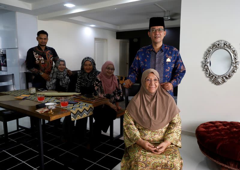 Tengku Shawal poses for photos with his family in Singapore