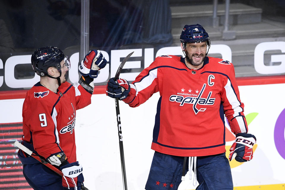 Washington Capitals left wing Alex Ovechkin, right, celebrates his goal with defenseman Dmitry Orlov (9) during the second period of an NHL hockey game against the New York Rangers, Sunday, March 28, 2021, in Washington. (AP Photo/Nick Wass)