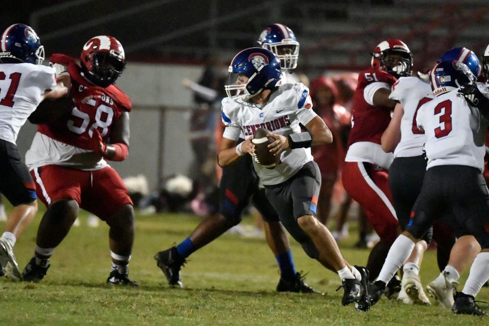 Christian Academy's Connor Hodge (1) rolls out of the pocket during the second half of their football game against Manual, Thursday, Sept. 26 2024 in Louisville Ky. Christian Academy won 35-10.