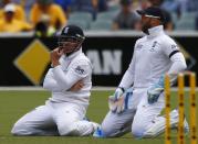 England's vice-captain Matt Prior (R) and teammate Ian Bell react after they missed a catch hit by Australia's captain Michael Clarke (not pictured) during the second day of the second Ashes test cricket match at the Adelaide Oval December 6, 2013.