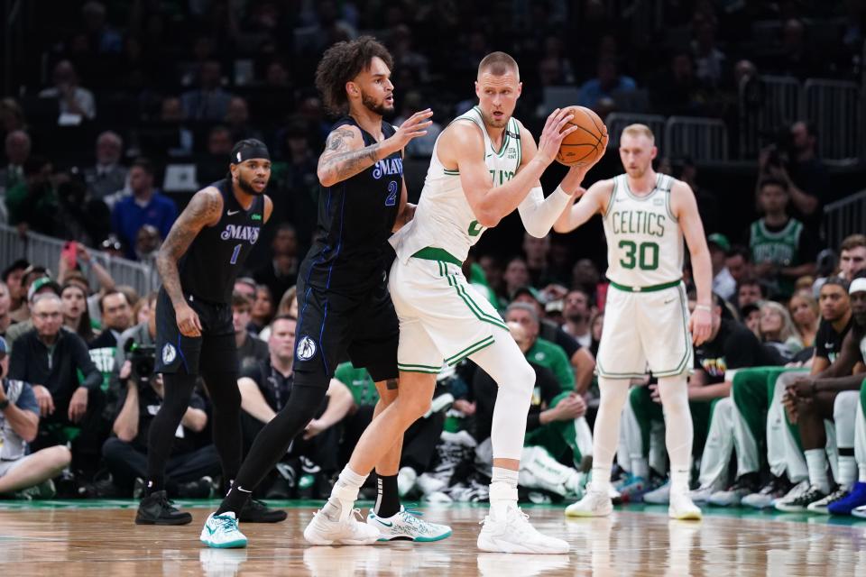 Celtics center Kristaps Porzingis controls the ball against Dallas center Dereck Lively II in the first quarter of Game 1 of the NBA Finals at TD Garden.