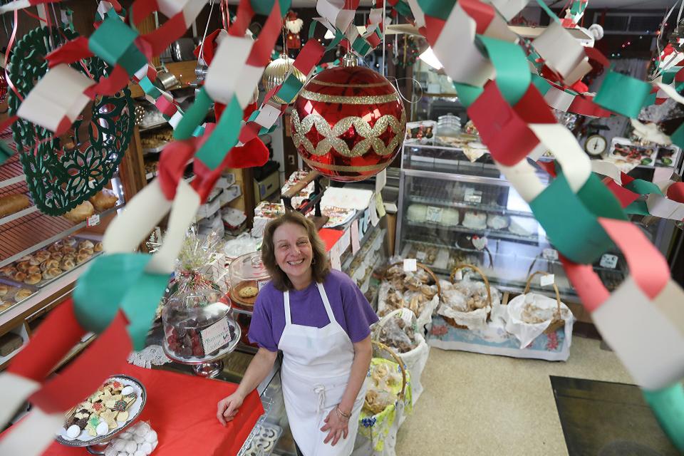 Cathrine Young, co owner of Varrelmann's German Bakery on Park Ave in Rutherford, NJ with Christmas decorations inside and out, including the chain garland that was made by a group of students over 20 years ago. It's one of the memories for the bakery that's been in business over 100 years.