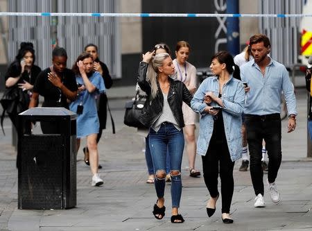 People rush out of the Arndale shopping centre as it is evacuated in Manchester, Britain May 23, 2017. REUTERS/Darren Staples