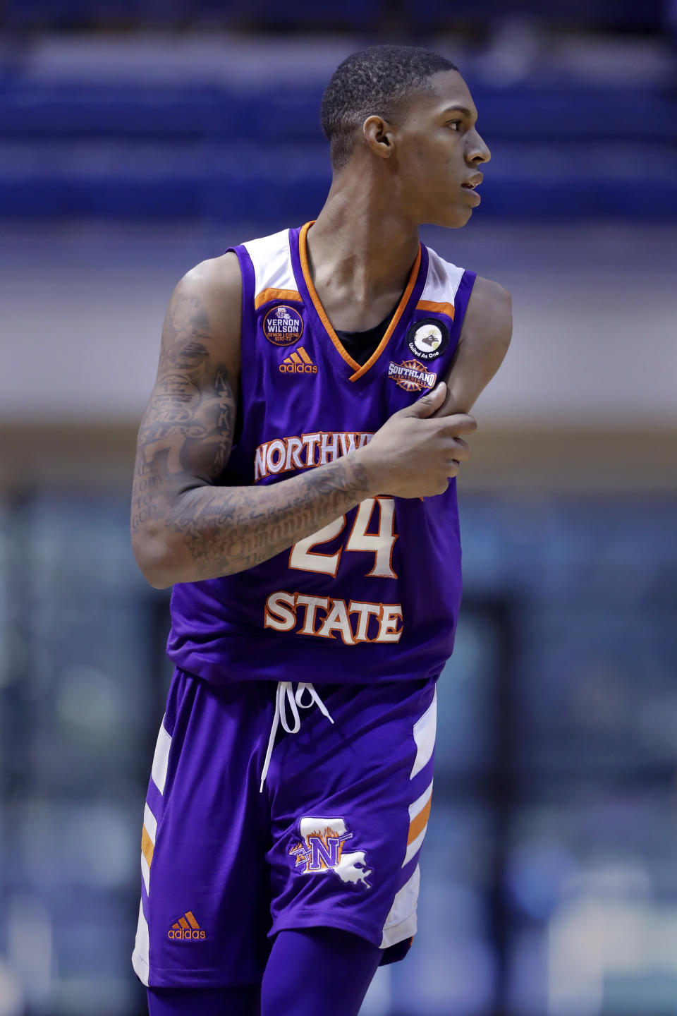 Hansel Enmanuel, a freshman guard from the Dominican Republic for Northwestern State, on the court during an NCAA college basketball game against Rice Saturday, Dec. 17, 2022, in Houston. Enmanuel lost his left arm in a childhood accident and has attained the talent and skill to play at the college level. (AP Photo/Michael Wyke)