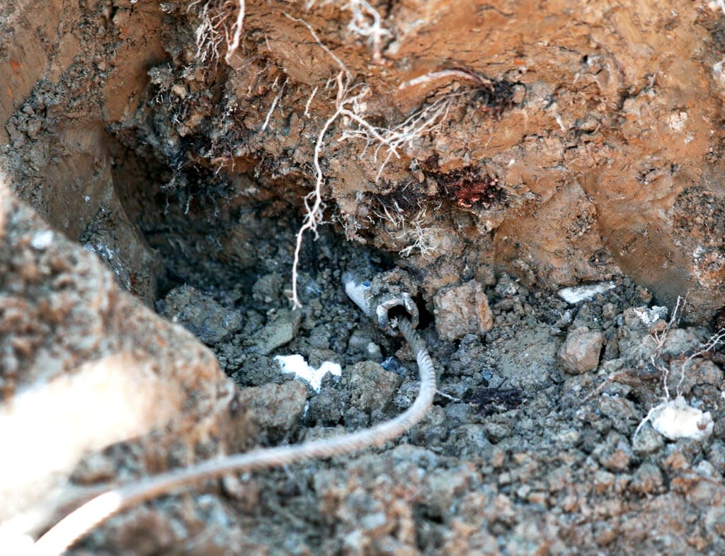 A lead service line water pipe is exposed by a City of Flint, Michigan work crew as workers prepare to replace the pipe at the site of the first Flint home with high lead levels to have its lead service line replaced under the Mayor’s Fast Start program on March 4, 2016 in Flint, Michigan. (Photo by Bill Pugliano/Getty Images)