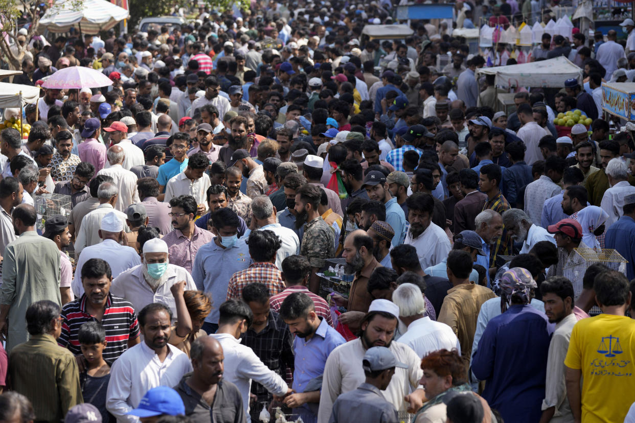 Pakistanis shops in a weekly pet market in Lahore, Pakistan, Monday, Nov. 13, 2022. (AP Photo/Fareed Khan)