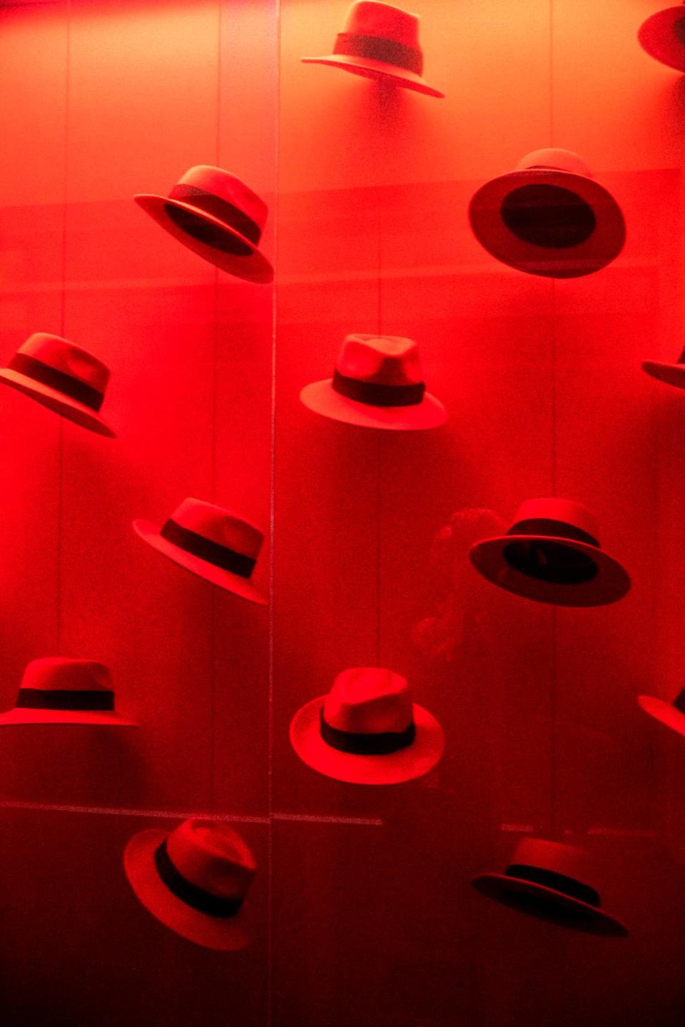 Red fedoras are on display inside Red Hat’s office building in Raleigh.