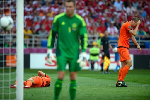 Dutch midfielder Wesley Sneijder (R) and forward Ibrahim Afellay react after missing a goal opportunity during their Euro 2012 championships Group B match against Denmark, on June 9, at the Metalist Stadium in Kharkiv. Denmark won 1-0