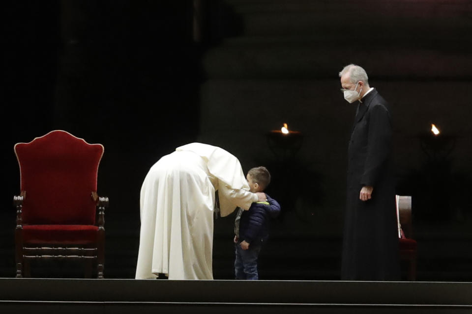 Pope Francis embraces a child after leading the Via Crucis – or Way of the Cross – ceremony in St. Peter's Square empty of the faithful following Italy's ban on gatherings to contain coronavirus contagion, at the Vatican, Friday, April 2, 2021. (AP Photo/Andrew Medichini)