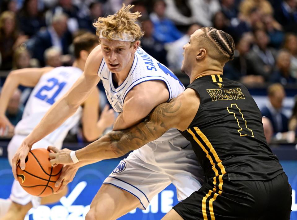 Brigham Young Cougars guard Richie Saunders (15) keeps the ball away from Southeastern Louisiana Lions guard Avery Wilson (1) as BYU and SE Louisiana play at the Marriott Center in Provo on Wednesday, Nov. 15, 2023. | Scott G Winterton, Deseret News