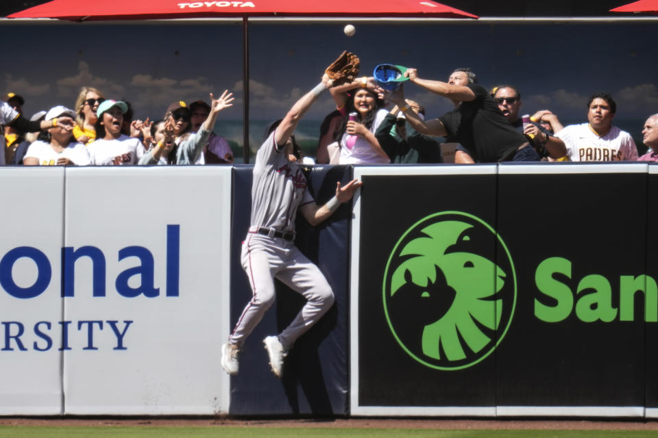 Atlanta Braves center fielder Sam Hilliard makes the catch over the wall for the out on San Diego Padres' Manny Machado during the fifth inning of a baseball game Wednesday, April 19, 2023, in San Diego. (AP Photo/Gregory Bull)