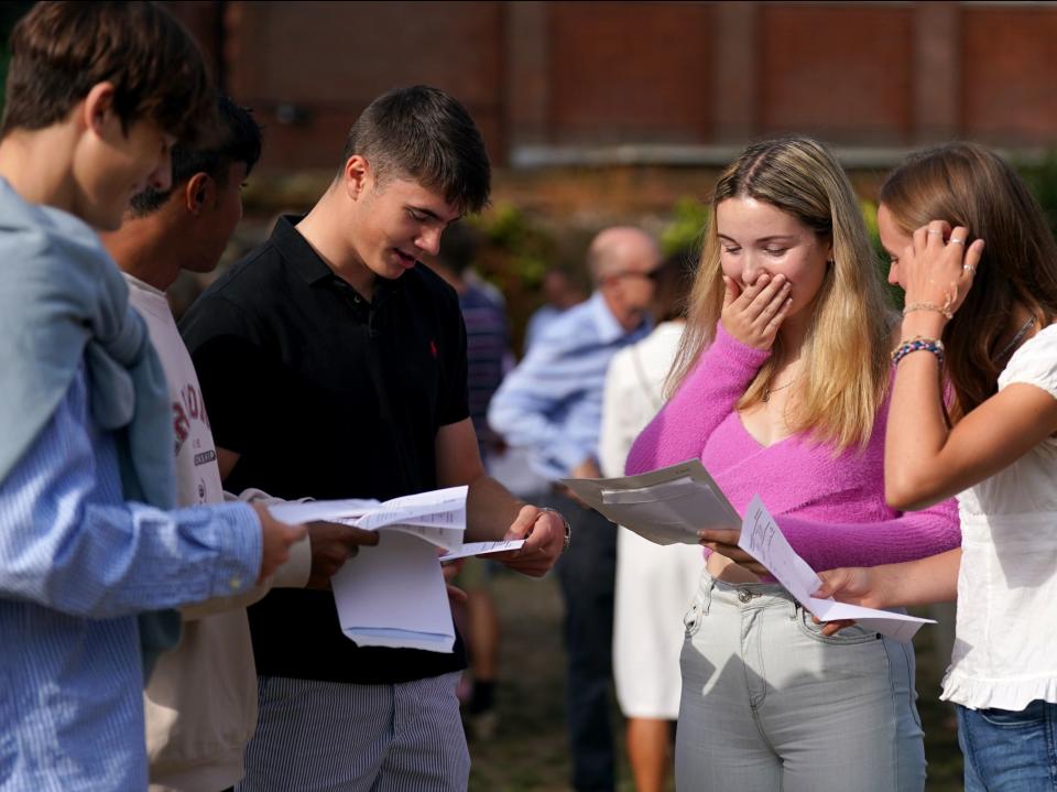 Anna Austin (centre-right) reacts when reading their A-level results at Norwich School (PA)
