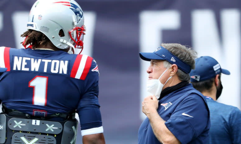 Cam Newton and Bill Belichick speak on the sideline during a New England Patriots game.