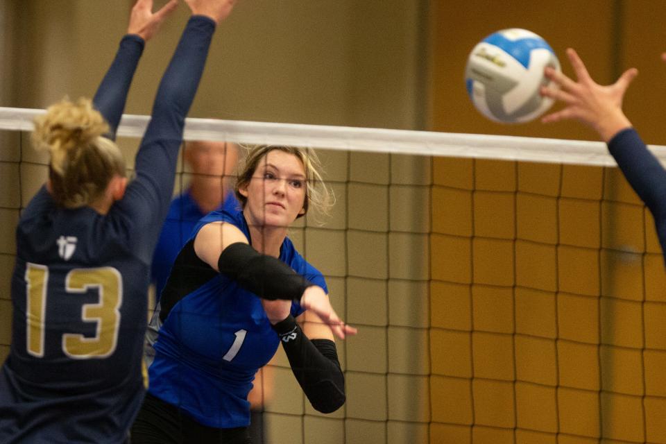 Washburn Rural senior Taylor Russell (1) narrowly makes it through St. Thomas Aquinas players on a spike during Thursday's match.