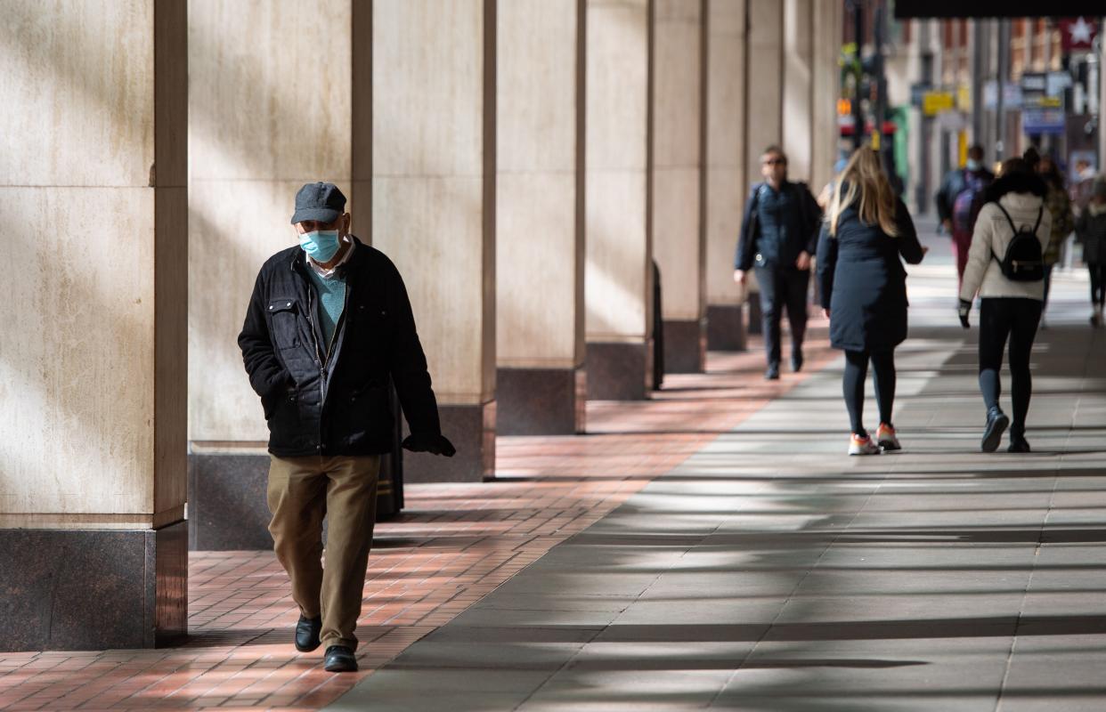 People wearing protective face masks (PA Wire)