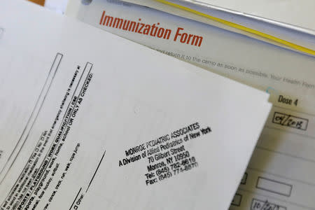 FILE PHOTO: A camper's immunization form and physician's stamp is seen at the Rosmarins Day Camp and Cottages office in Monroe, New York, U.S., May 20, 2019. Picture taken May 20, 2019. REUTERS/Mike Segar