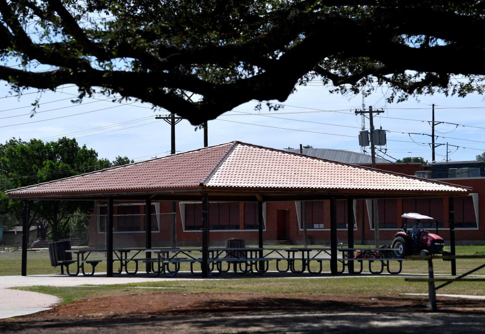 An Abilene city employee mows the grass behind a new pavilion at Stevenson Park Wednesday.