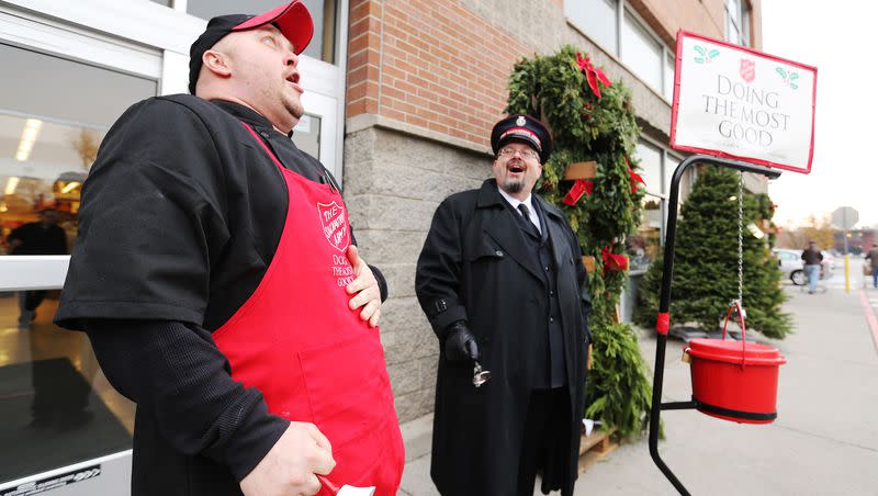 Smith’s deli chef Phil Hunt, left, and the Salvation Army’s Troy Trimmer sing as they collect donations at Smith’s Marketplace in Salt Lake City on Dec. 4, 2015. A report shows charitable giving fell slightly in 2022.