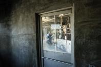 A worker milks cows at Wickstrom Jersey Farms on Thursday, May 9, 2024, in Hilmar, Calif. The farm uses a diary digester to capture methane from cow manure which generates energy in an effort to reduce greenhouse gas emissions. (AP Photo/Noah Berger)