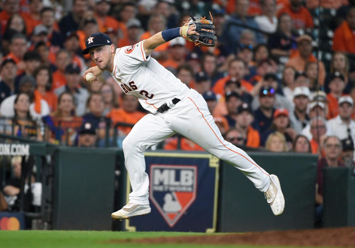 FILE - In this Oct. 4, 2019, file photo, Houston Astros third baseman Alex Bregman looks to first after fielding a grounder by Tampa Bay Rays' Tommy Pham, who was safe at first in the seventh inning during Game 1 of a baseball American League Division Series in Houston.