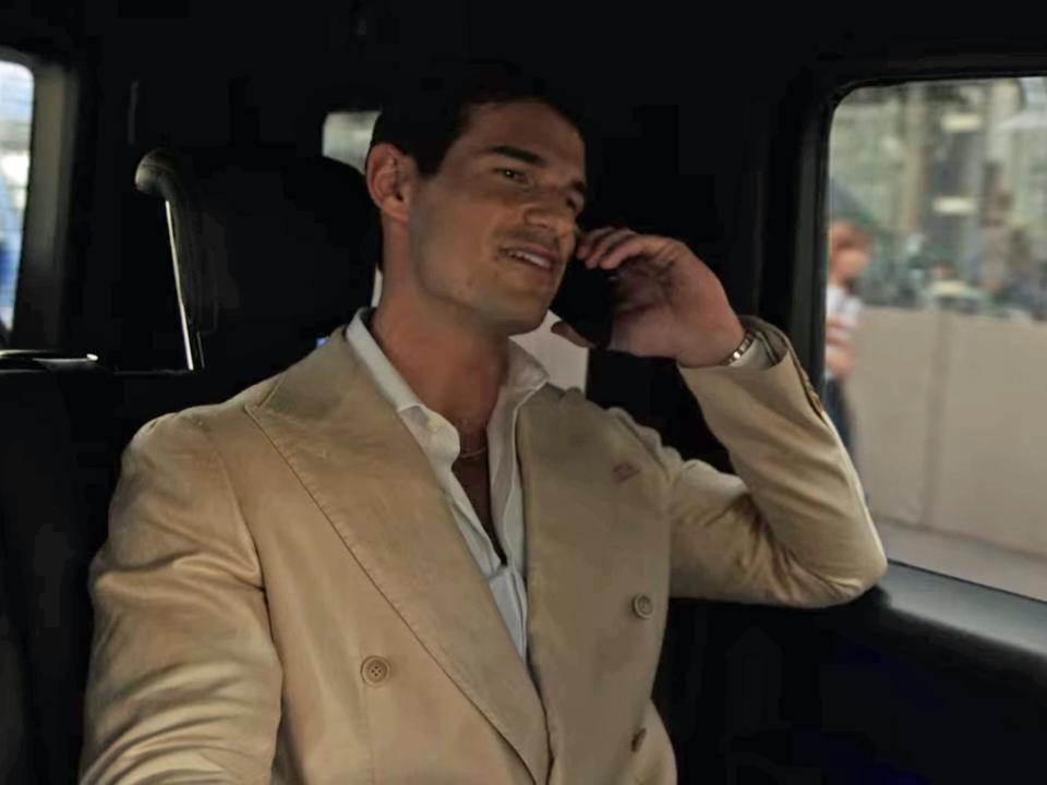 nicolas talking on the phone in a car on the season three finale of emily in paris