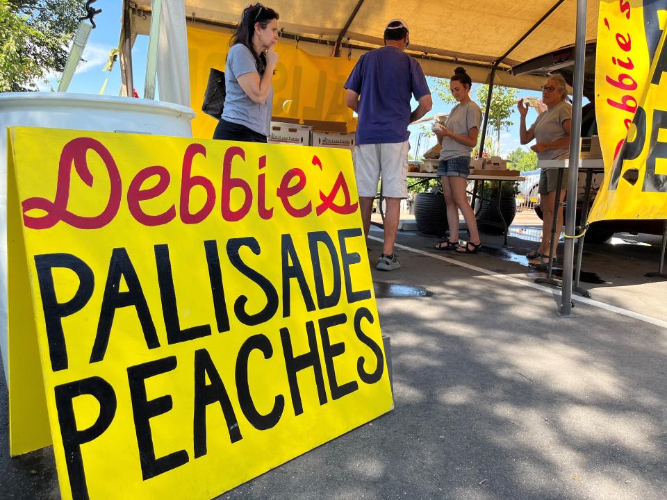 Customers line up to purchase peaches at the Debbie's Palisade Peaches stand at Bath Garden and Nursery, 2000, E. Prospect Road, Fort Collins, Colo., on Tuesday, Aug. 23, 2022.