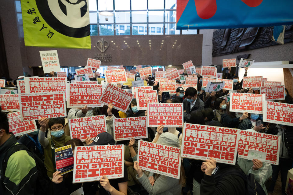 HONG KONG, CHINA - 2020/02/04: Medicals staffs holding placards during the strike at the Hospital Authority building.
Thousands of medical staffs took part in a industrial strike to demand the Hong Kong government to close all the border crossing with Mainland China to protect Hong Kong from the Coronavirus being spread from Mainland China. (Photo by Geovien So/SOPA Images/LightRocket via Getty Images)