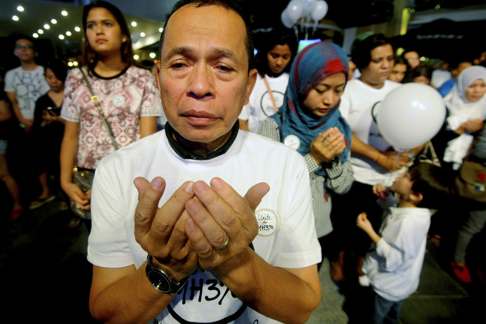 In this picture taken on Tuesday, March 18, 2014 a Malaysian Muslim man prays during an interfaith event for the missing Malaysia Airlines flight MH370 at a shopping mall in Petaling Jaya outside Kuala Lumpur, Malaysia. The Malaysia Airline plane, which was heading to Beijing, disappeared early March 8 about an hour after take-off from Kuala Lumpur. Military radar showed the plane backtracked toward the Strait of Malacca, just west of Malaysia. Aircraft and ships are scouring two giant arcs of territory amounting to the size of Australia - half of it in the remote waters of the southern Indian Ocean. (AP Photo/Joshua Paul)