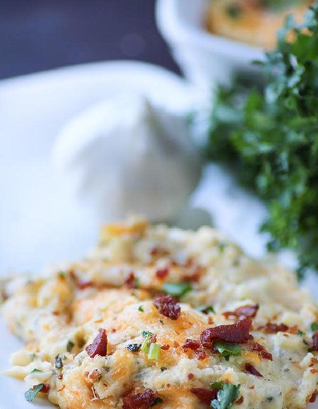 <p>Swanky Recipes</p><p>Cheesy Mashed Potato Casserole is classic comfort food at its finest. This dish is made with sour cream, cream cheese, melted cheddar cheese and spices and then topped with bacon, green onions and parsley. <a href="http://www.swankyrecipes.com/cheesy-mashed-potato-casserole.html" rel="nofollow noopener" target="_blank" data-ylk="slk:Get the recipe here.;elm:context_link;itc:0;sec:content-canvas" class="link rapid-noclick-resp">Get the recipe here.</a></p>