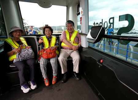 Local residents are seen inside Robot Shuttle, a driver-less, self driving bus, developed by Japan's internet commerce and mobile games provider DeNA Co., during an experimental trial with a self-driving bus in a community in Nishikata town, Tochigi Prefecture, Japan September 8, 2017. REUTERS/Issei Kato