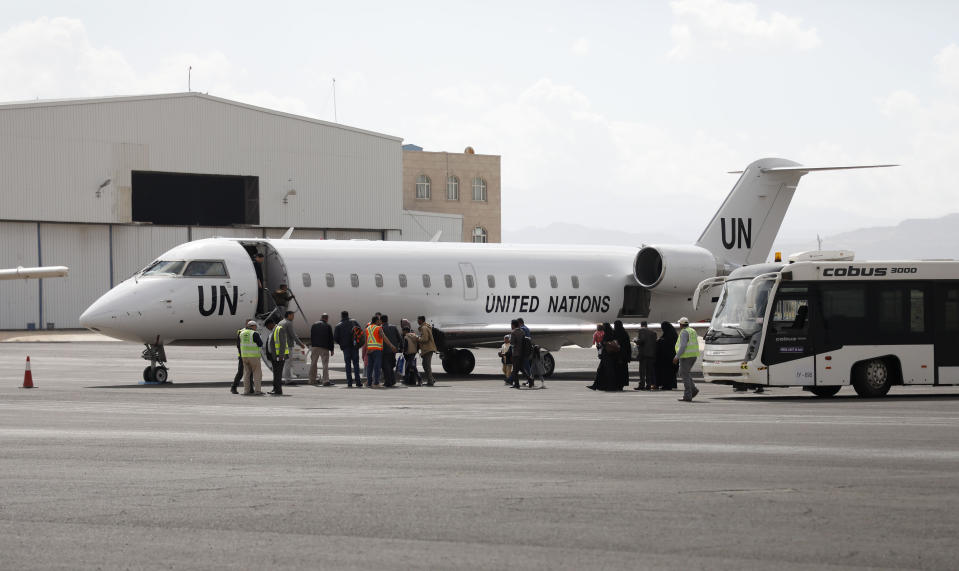 Yemenis board a United Nation plane at Sanaa International airport, Yemen, Monday, Feb. 3, 2020. The United Nations medical relief flight carrying patients from Yemen's rebel-held capital was the first in over three years. The U.N. said eight patients and their families were flown to Egypt and Jordan to receive “life-saving specialized care not available in Yemen." (AP Photo/Hani Mohammed)