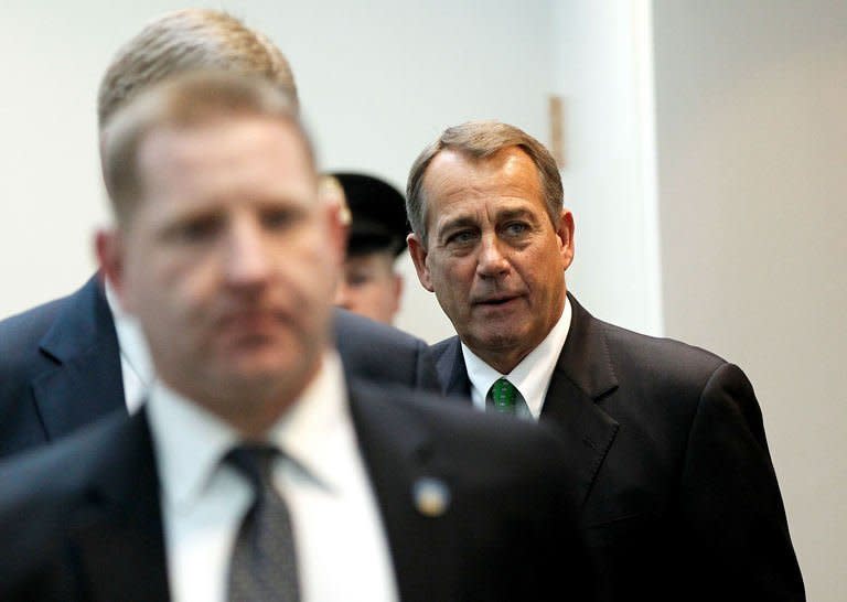 House Speaker John Boehner emerges from a meeting with House Republicans at the US Capitol on January 1, 2013 in Washington. After a day of twisting political drama, the US Congress was expected to finally endorse a deal to avert the "fiscal cliff" budget crisis that had threatened to unleash a new recession