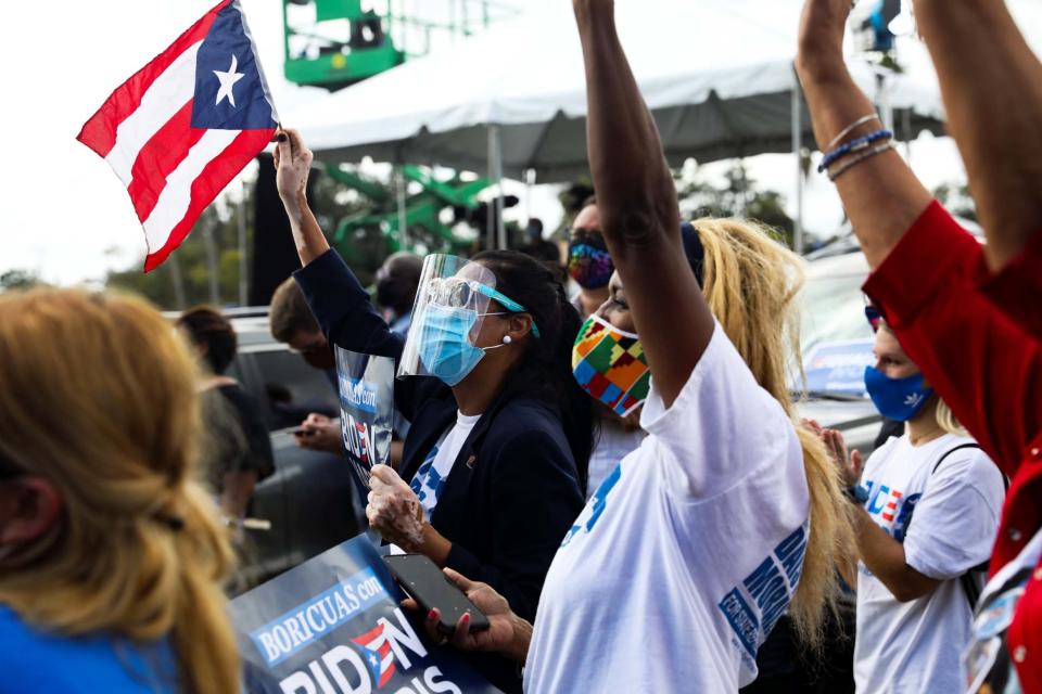 Biden supporters cheer while attending a drive-in rally hosted by former US President Barack Obama (REUTERS)