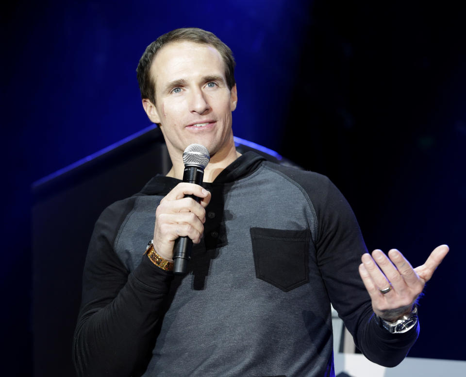 This Jan. 30, 2014 photo shows New Orleans Saints' Drew Brees during a video game tournament next to the Bud Light Hotel in New York. Norwegian Cruise Line’s just-launched ship Norwegian Getaway is serving as a floating hotel for Super Bowl weekend events sponsored by the beer brand Bud Light. Renamed the Bud Light Hotel New York, the ship is docked at Pier 88 in Manhattan on the Hudson. Its 18 decks house 4,000 guests in 1,900 staterooms. Those aboard are mostly connected to Bud Light's retailers, partners and VIP guests. (AP Photo)