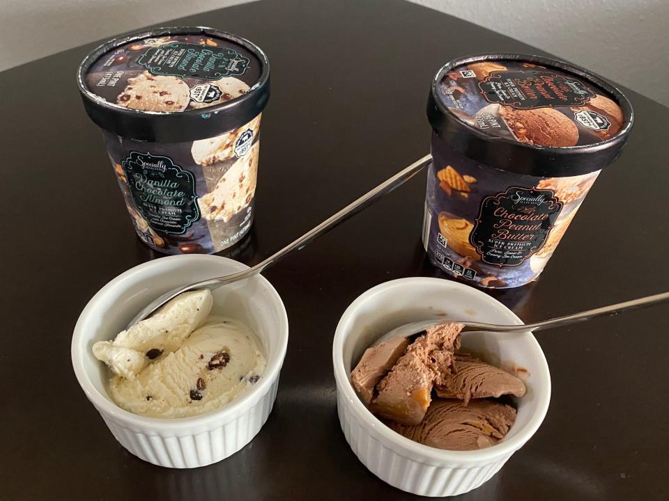 Scoops of Specially Selected vanilla-chocolate-almond and chocolate-peanut-butter ice cream with containers behind them