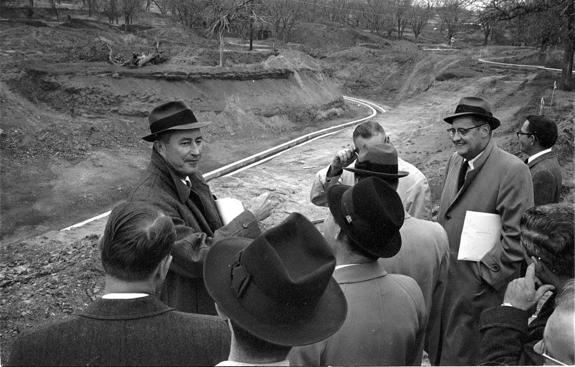 Dec. 13, 1960: Angus Wynne, Jr., founder of Six Flags Over Texas in Arlington, points out where the LaSalle River Adventure ride will be built during a 1960 inspection tour.