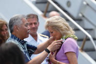 First lady Jill Biden receives a lei of flowers from Hawaii Gov. David Ige on the tarmac after arriving at Joint Base Pearl Harbor-Hickam, Hawaii, Saturday, July 24, 2021. (Jamm Aquino/Honolulu Star-Advertiser via AP)