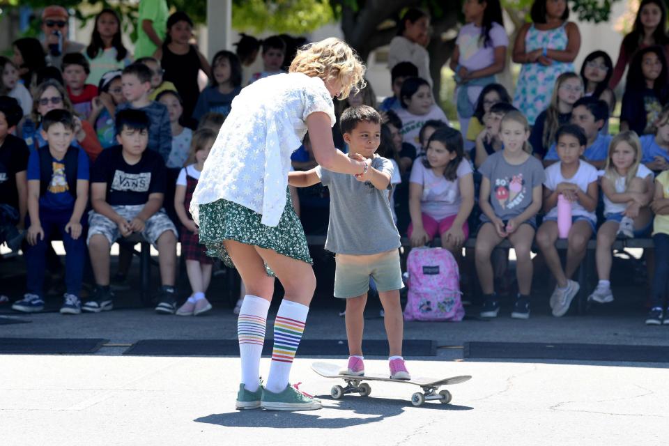 X Games athlete Bryce Wettstein shows Niko Tibay, 5, how to skate during a demonstration at ATLAS Elementary School in Ventura on Tuesday.