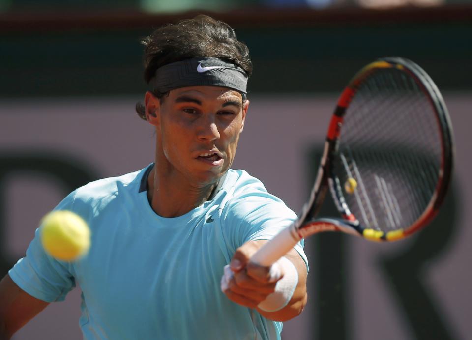 Rafael Nadal of Spain returns the ball to Andy Murray of Britain during their men's semi-final match at the French Open tennis tournament at the Roland Garros stadium in Paris June 6, 2014. REUTERS/Gonzalo Fuentes (FRANCE - Tags: SPORT TENNIS)