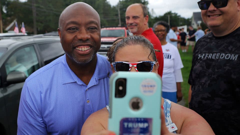 Republican presidential candidate Sen. Tim Scott poses for a selfie at the start of the the Fourth of July Parade in Merrimack, New Hampshire, on July 4.  - Brian Snyder/Reuters