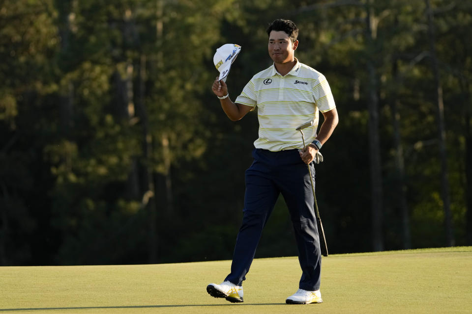 Hideki Matsuyama, of Japan, waves his cap after winning the Masters golf tournament on Sunday, April 11, 2021, in Augusta, Ga. (AP Photo/David J. Phillip)