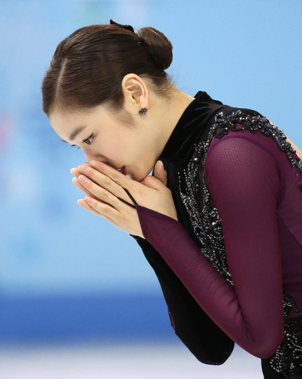 Yuna Kim of South Korea reacts after completing her routine in the women's free skate figure skating finals at the Iceberg Skating Palace during the 2014 Winter Olympics, Thursday, Feb. 20, 2014, in Sochi, Russia. (AP Photo/Bernat Armangue)