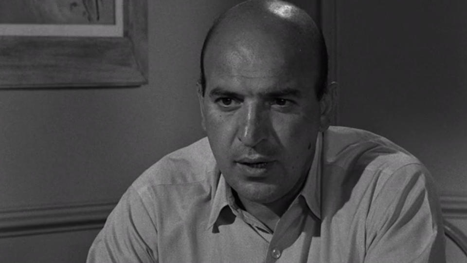 <p> "Who loves you, baby?" It's one of the most iconic catchphrases in TV history, made famous by Telly Savalas in <em>Kojak</em>. A decade before he starred as the super cool TV detective, he played a gruff stepfather who gets into a fight with his stepdaughter's baby doll in the Season 5 episode "Living Doll." </p>